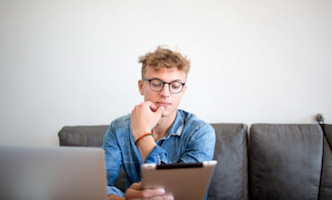 jonge man kijkt op laptop